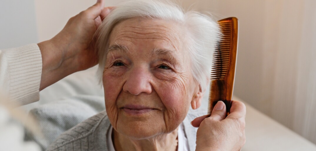 Close up of older woman getting her hair brushed