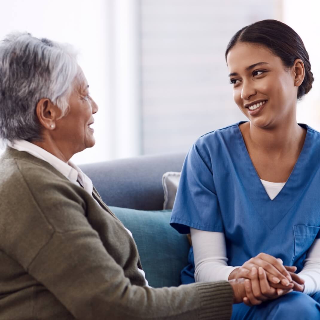 Female healthcare professional working with older female