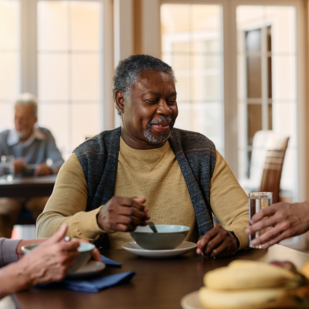 Older man eating soup, residential care