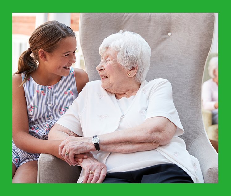 Young girl with grandmother, holding hands, both smiling